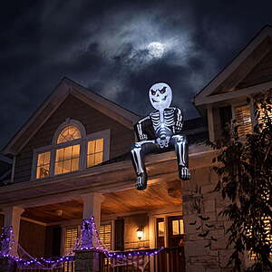 Joyfy 8.5 FT Halloween Inflatable Rooftop Skeleton with Built-in LED,Blow Up Skeleton Inflatable for Window Decoration Yard Garden Lawn Decor $45.99